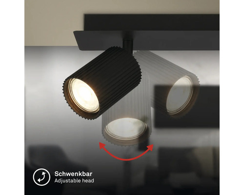 Spot orientable noir avec boîtier nervuré, illustration de la fonction de pivotement de la tête de lampe.