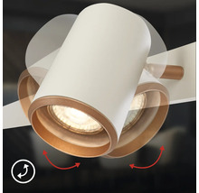 Spot cylindrique orientable avec un boîtier blanc et un bord intérieur doré, illustrant la fonction de pivotement.