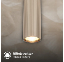 Luminaire cylindrique avec texture nervurée et lumière.