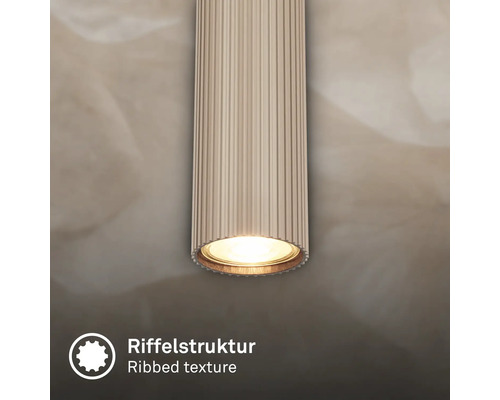 Luminaire cylindrique avec texture nervurée et lumière.
