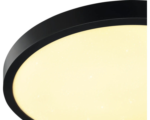 Plafonnier LED rond avec bord noir et diffuseur à effet ciel étoilé.