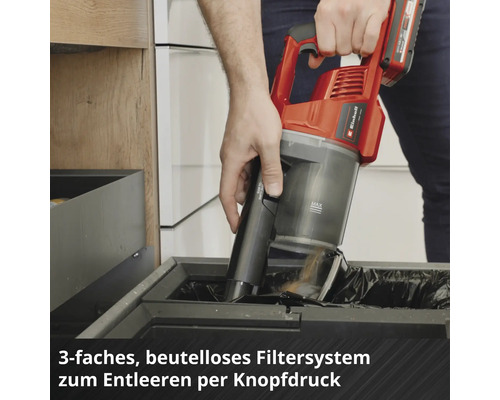 Aspirateur à main sans fil Einhell vidé d'une simple pression sur un bouton au-dessus d'une poubelle.
