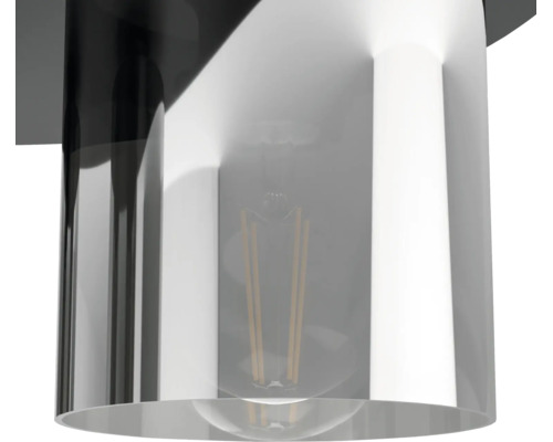 Detailansicht eines zylindrischen Lampenschirms mit sichtbarem Filament-Leuchtmittel.