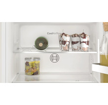 Vue intérieure d'un réfrigérateur Bosch avec technologie CoolAirflow, étagères en verre, porte-bouteilles et aliments dans des verres.