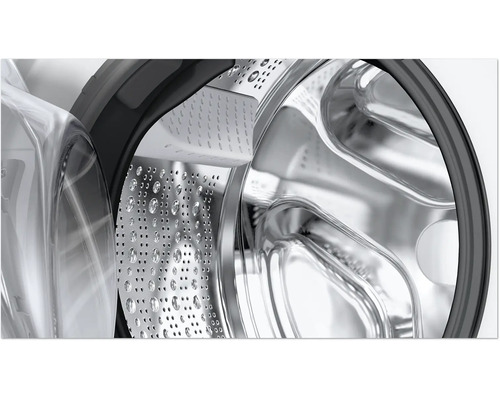 Vue détaillée du tambour en acier inoxydable d'une machine à laver avec aubes de tambour et hublot