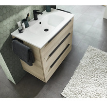 Meuble sous-vasque moderne avec deux tiroirs, lavabo blanc, robinet et porte-serviettes dans une salle de bains élégante.