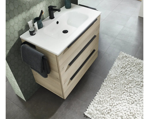 Meuble sous-vasque moderne avec deux tiroirs, lavabo blanc, robinet et porte-serviettes dans une salle de bains élégante.