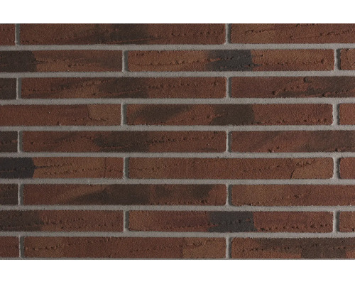 Mur en briques texturées avec plaquettes de parement irrégulières en appareil à joints croisés.