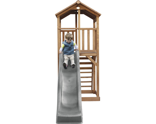 Un enfant glisse sur un toboggan de tour de jeu.