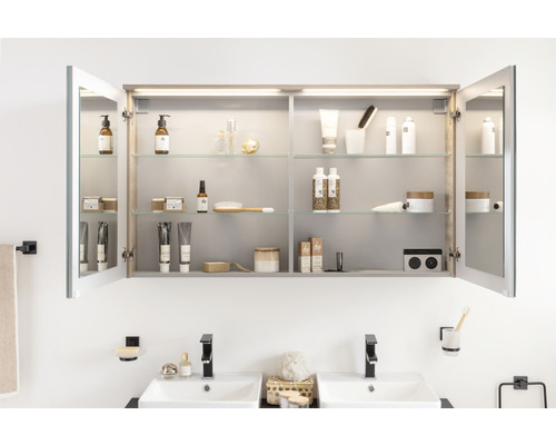 Armoire de toilette ouverte avec accessoires de salle de bain au-dessus d''un lavabo double