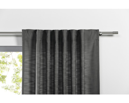 Rideau gris sur une tringle à rideaux devant une fenêtre.