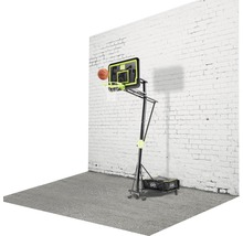 Panier de basket réglable avec ballon devant un mur blanc