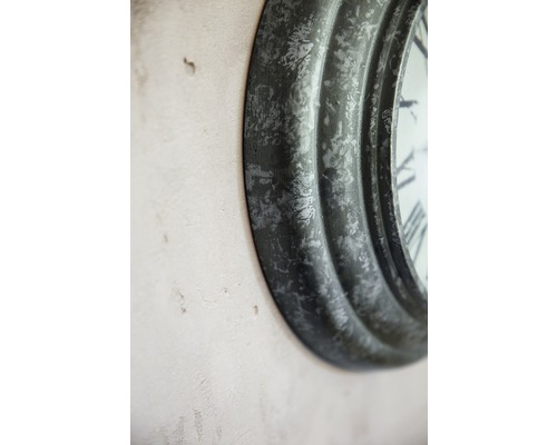 Detail einer runder Wanduhr mit römischen Ziffern