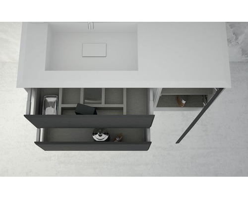 Meuble sous-vasque avec tiroirs ouverts pour ranger les accessoires de salle de bain.