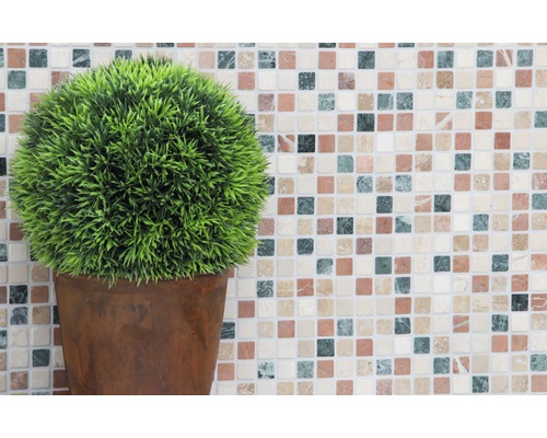 Künstliche Pflanze im Topf vor Mosaikhintergrund