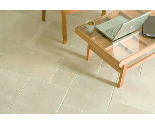 Pose de carreaux en pierre naturelle avec table basse, ordinateur portable et tasse à café