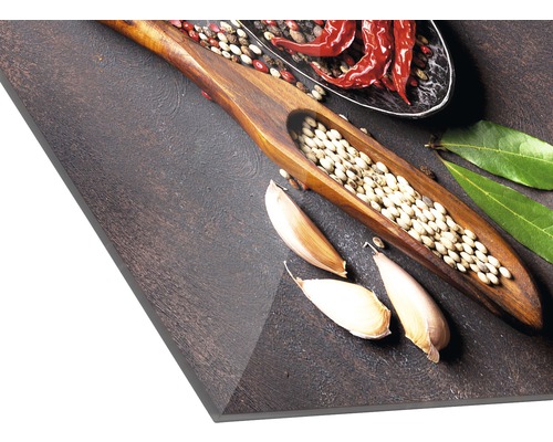 Gewürze wie Knoblauch, Pfeffer und Chili auf einem Schneidebrett