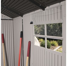Vue intérieure d''une remise de jardin avec fenêtre et outils de jardinage