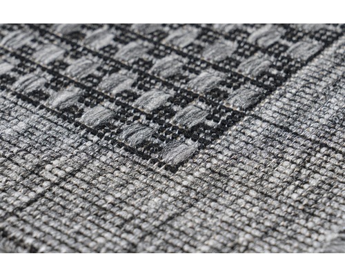 Gros plan d''un tapis gris avec motif