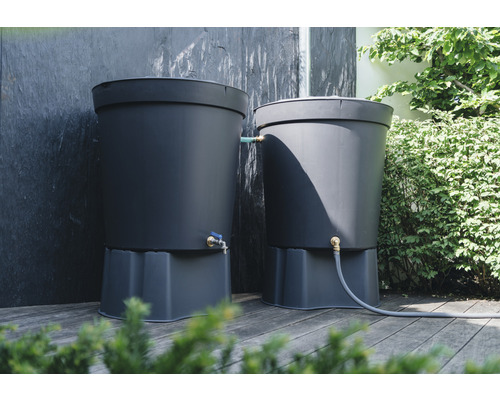 Zwei Regentonnen aus Kunststoff mit Hähnen und Schlauch auf einer Holzterrasse