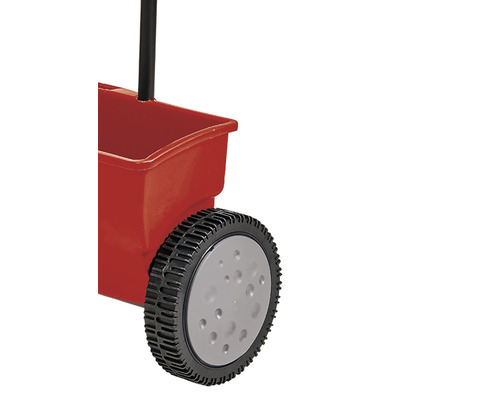 Vue détaillée d''un épandeur avec récipient rouge et poignée noire