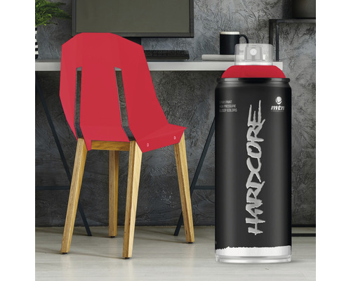 Bombe de peinture avec peinture rouge à côté d''une chaise