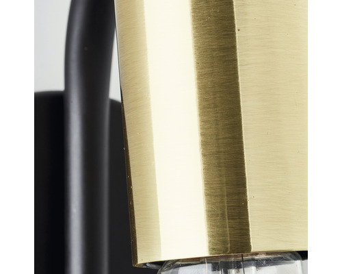 Detailaufnahme einer Messing-Leuchte mit schwarzem Lampenarm