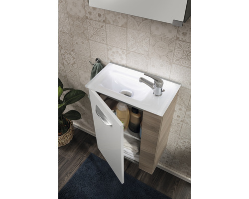 Salle de bain avec meuble sous-lavabo avec porte ouverte, lavabo et robinetterie