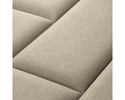 Gros plan d''un canapé beige avec une surface matelassée