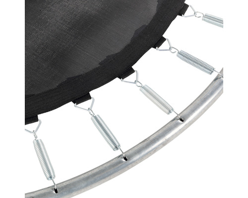 Gros plan d''un trampoline avec ressorts, toile de saut et cadre