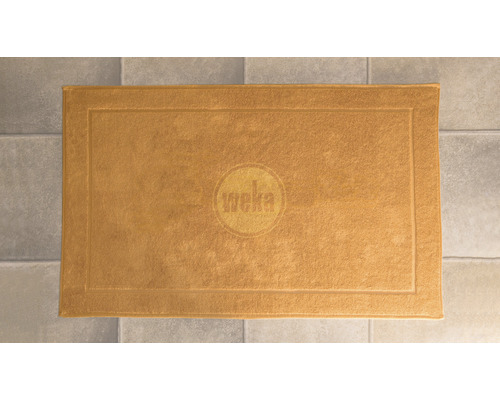 Logo Weka sur un tapis de bain