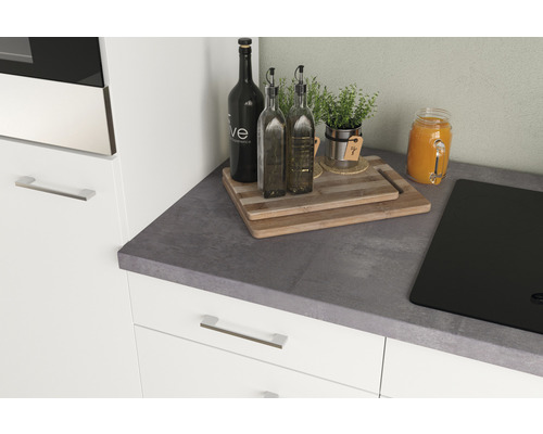 Scène de cuisine avec plan de travail, plaque de cuisson, planches à découper, bouteilles d''huile, herbes aromatiques et jus de fruits