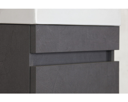 Gros plan d''un meuble sous-lavabo de salle de bains avec deux tiroirs et un couvercle en céramique blanche