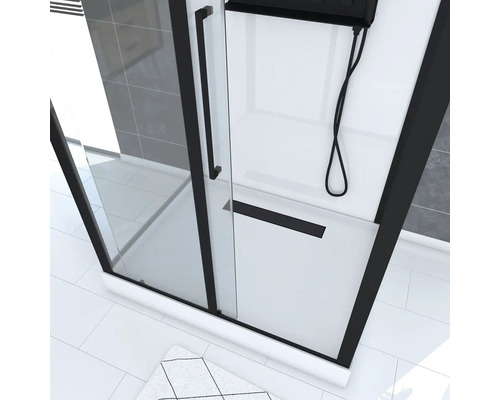 Douche d''angle avec cadre noir, paroi en verre et receveur de douche blanc.
