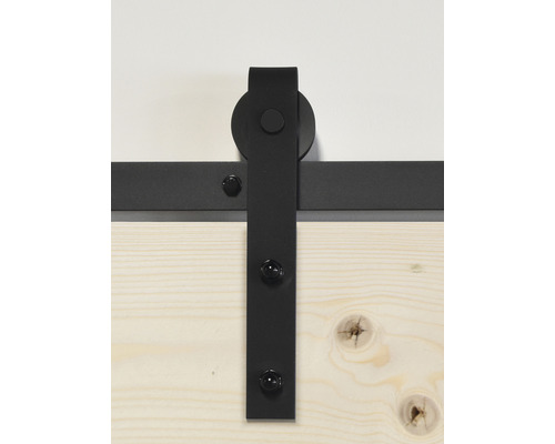 Quincaillerie de porte coulissante en métal noir sur porte en bois