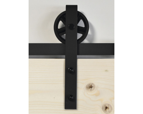 Ferrure de porte coulissante avec roulette et rail sur une porte en bois