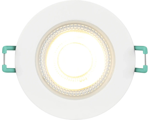 Spot LED encastrable rond avec cadre blanc et lumière blanc chaud allumée.