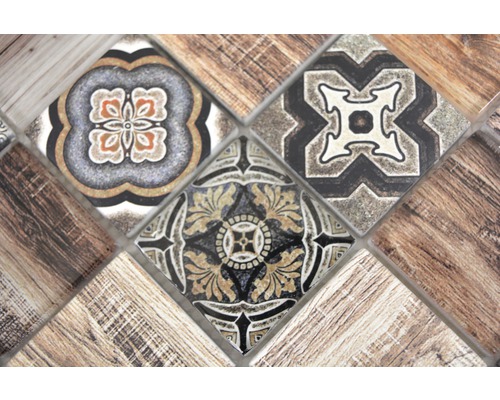 Nahaufnahme von Mosaikfliesen mit floralen und Holz-Mustern.