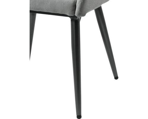 Detailansicht eines Stuhls mit Stoffbezug und Metallbeinen