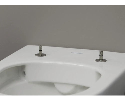 Gros plan de toilettes Duravit blanches avec boulons de fixation