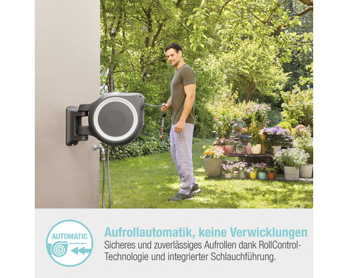 Gartenszene mit Mann, der einen Schlauch von einer automatischen Schlauchaufrollerbox verwendet