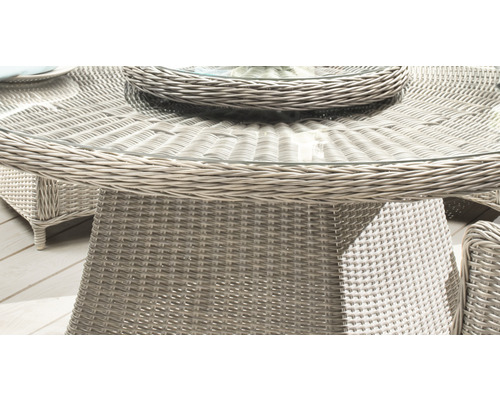 Nahaufnahme eines runden Gartentisches mit Glasplatte und Rattanstruktur