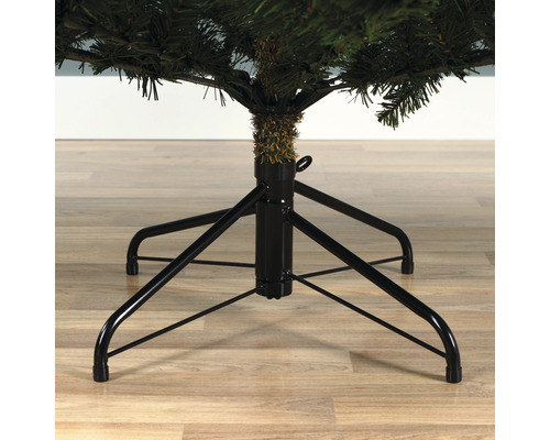 Christbaumständer mit vier Beinen unter einem künstlichen Weihnachtsbaum