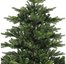 Gros plan sur un arbre de Noël artificiel avec des aiguilles vertes.