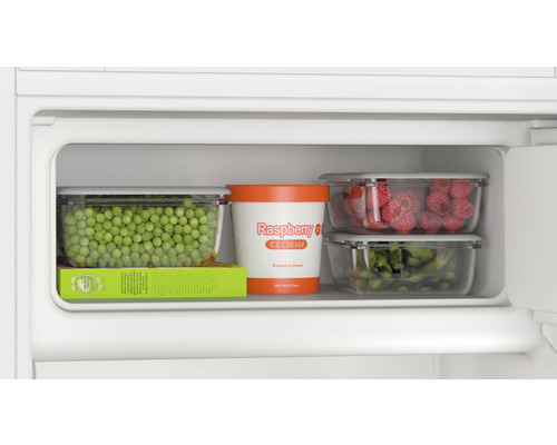 Compartiment de congélation avec petits pois, glace à la framboise, framboises et edamame