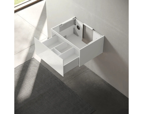 Meuble sous-lavabo avec tiroir ouvert et compartiments pour le rangement de la salle de bain