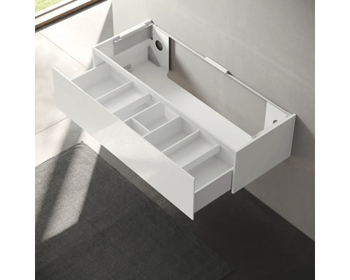 Meuble sous-lavabo blanc avec tiroirs pour rangement dans la salle de bain.