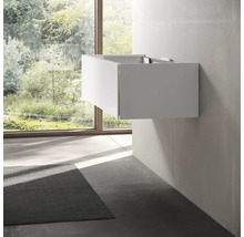 Salle de bains moderne avec meuble sous-lavabo et fenêtre donnant sur la verdure.