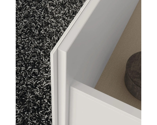 Vue détaillée d''un meuble blanc avec tiroir et tapis