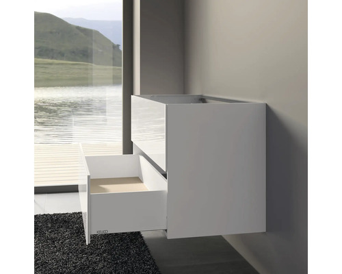 Meuble sous-lavabo avec tiroir ouvert dans une salle de bain